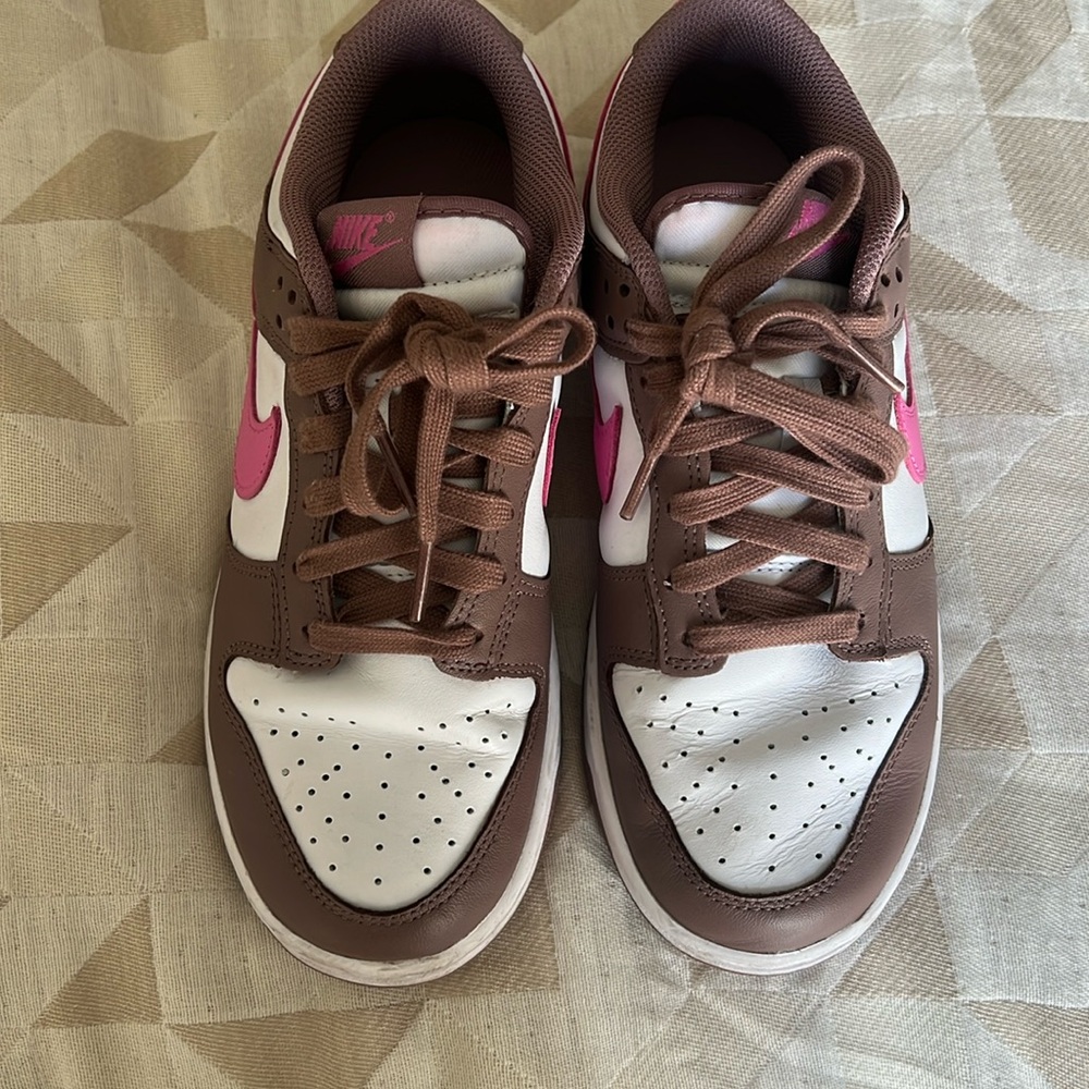 Chocolate and pink low top dunks.